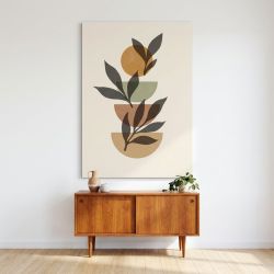 Tableau d'art moderne boho avec des formes géométriques et une palette d'ocre et vert sur fond clair, accroché au mur au-dessus 