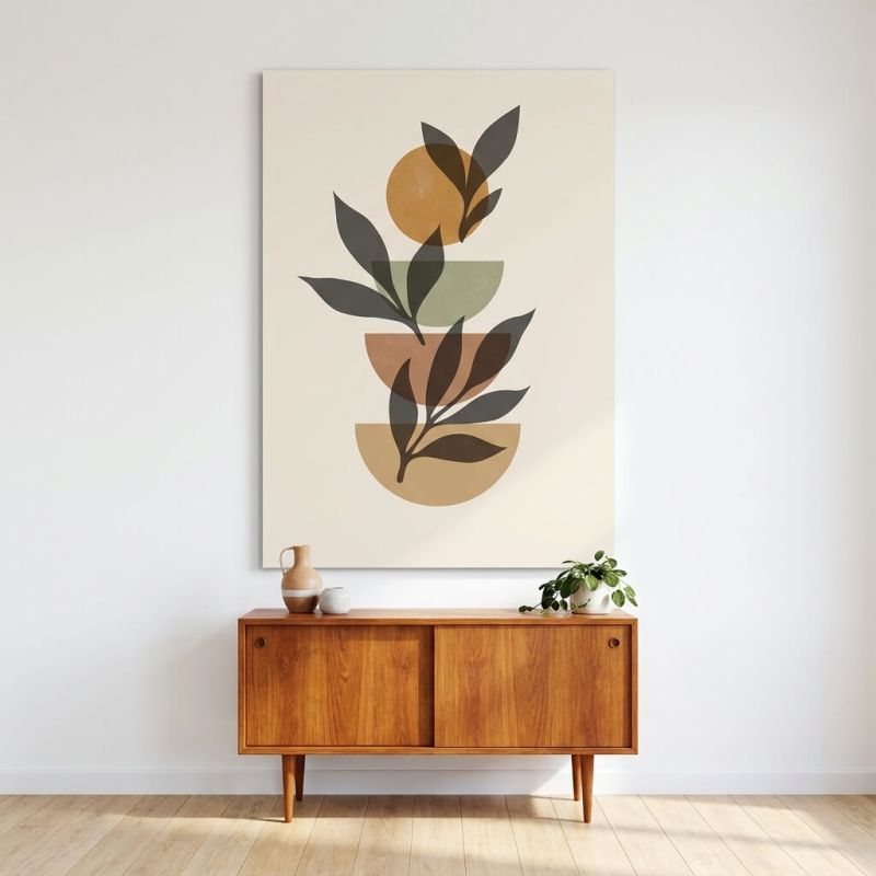 Tableau d'art moderne boho avec des formes géométriques et une palette d'ocre et vert sur fond clair, accroché au mur au-dessus 